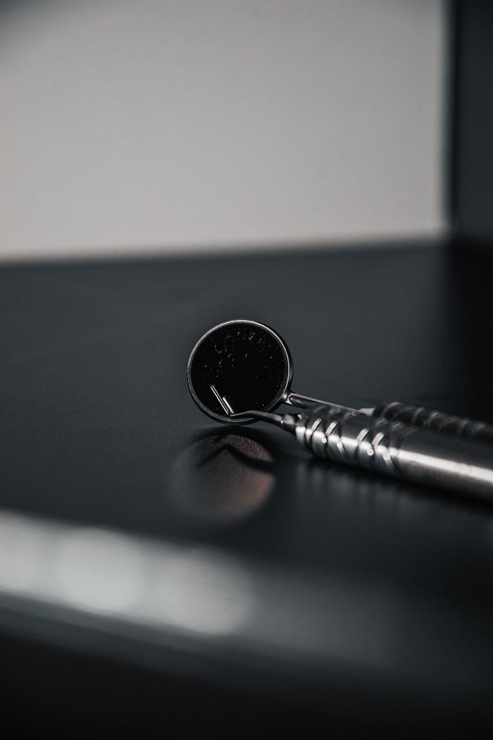 A detailed view of a dental mirror used in healthcare settings, perfect for medical themes.